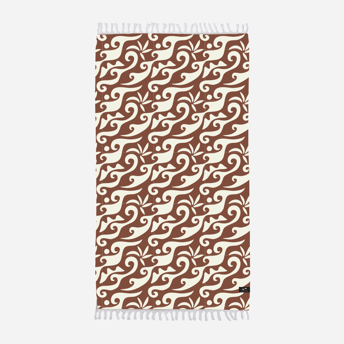 Oversized beach towel with brown and cream abstract swirls and white fringe edges.