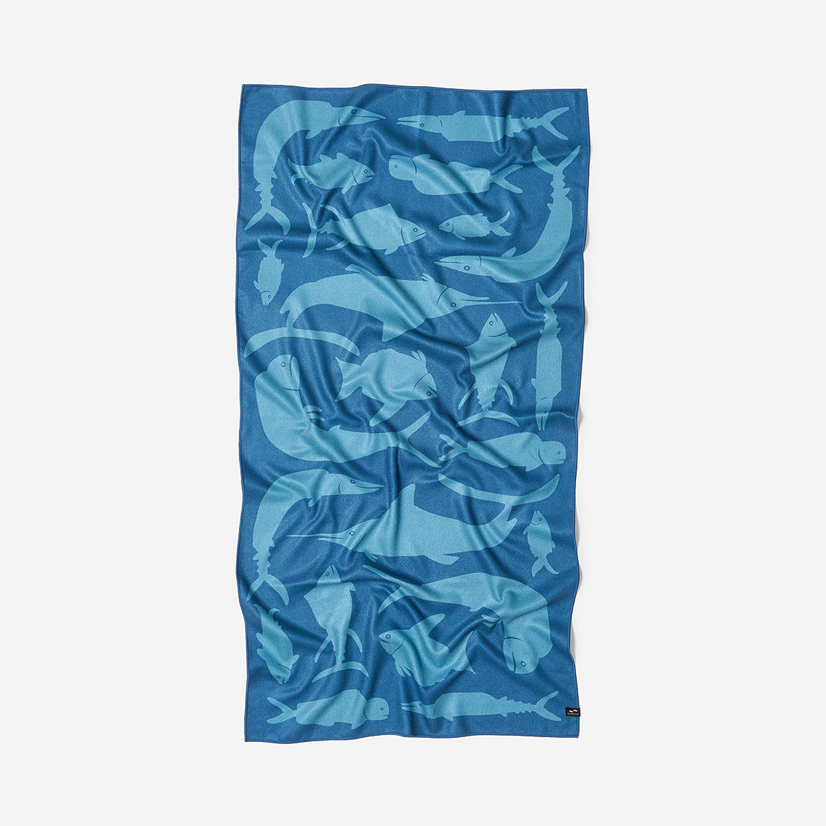 Sand-free towel with light blue fish pattern.