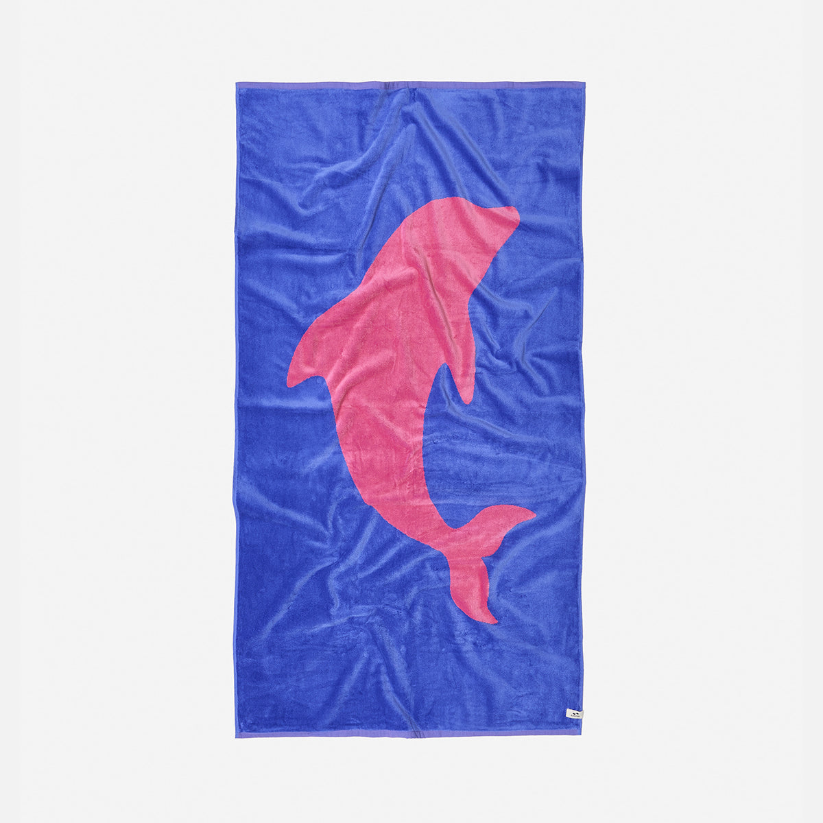Blue woven towel with large pink dolphin graphic.
