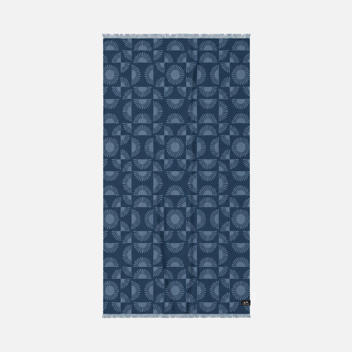 Turkish towel, sand-resistant cotton, indigo with light blue sunburst pattern and fringed edges.