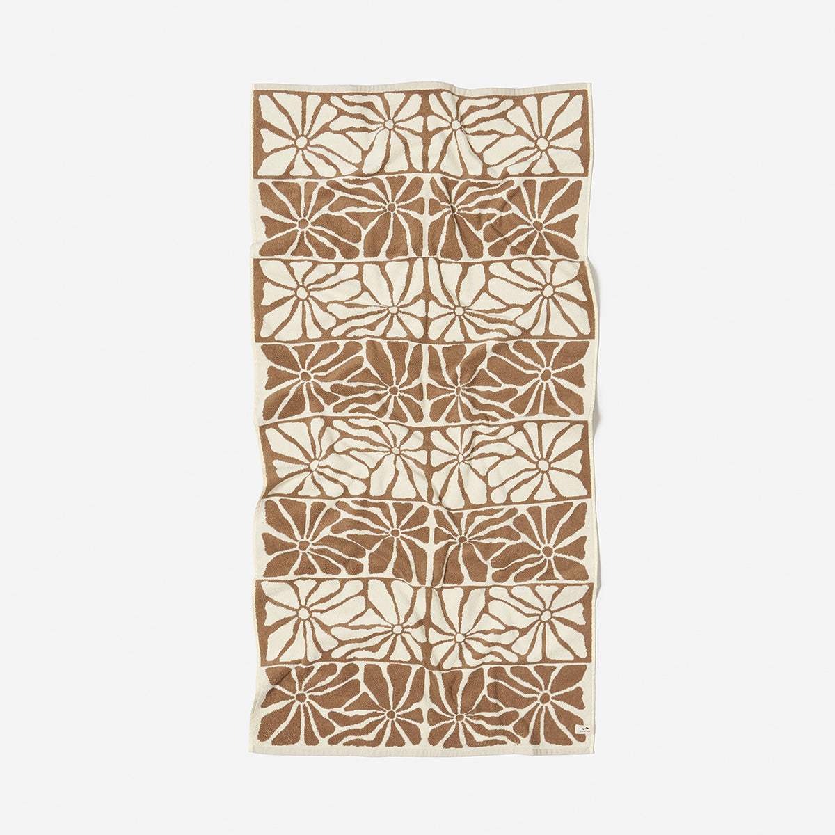 Cotton towel with brown floral stripe pattern, absorbent, shown flat on white background.