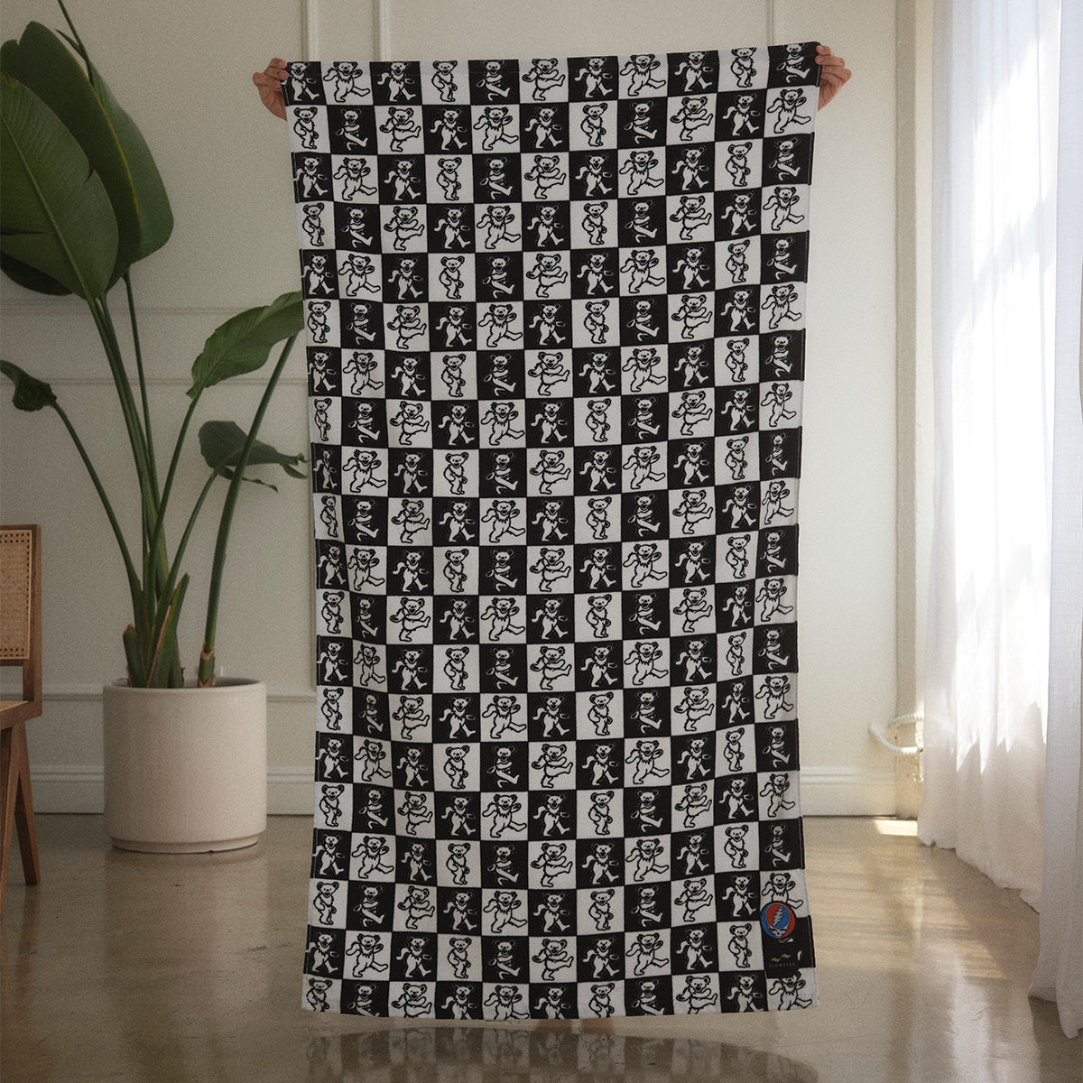 Cotton towel with black and white dancing bears pattern in a modern room.