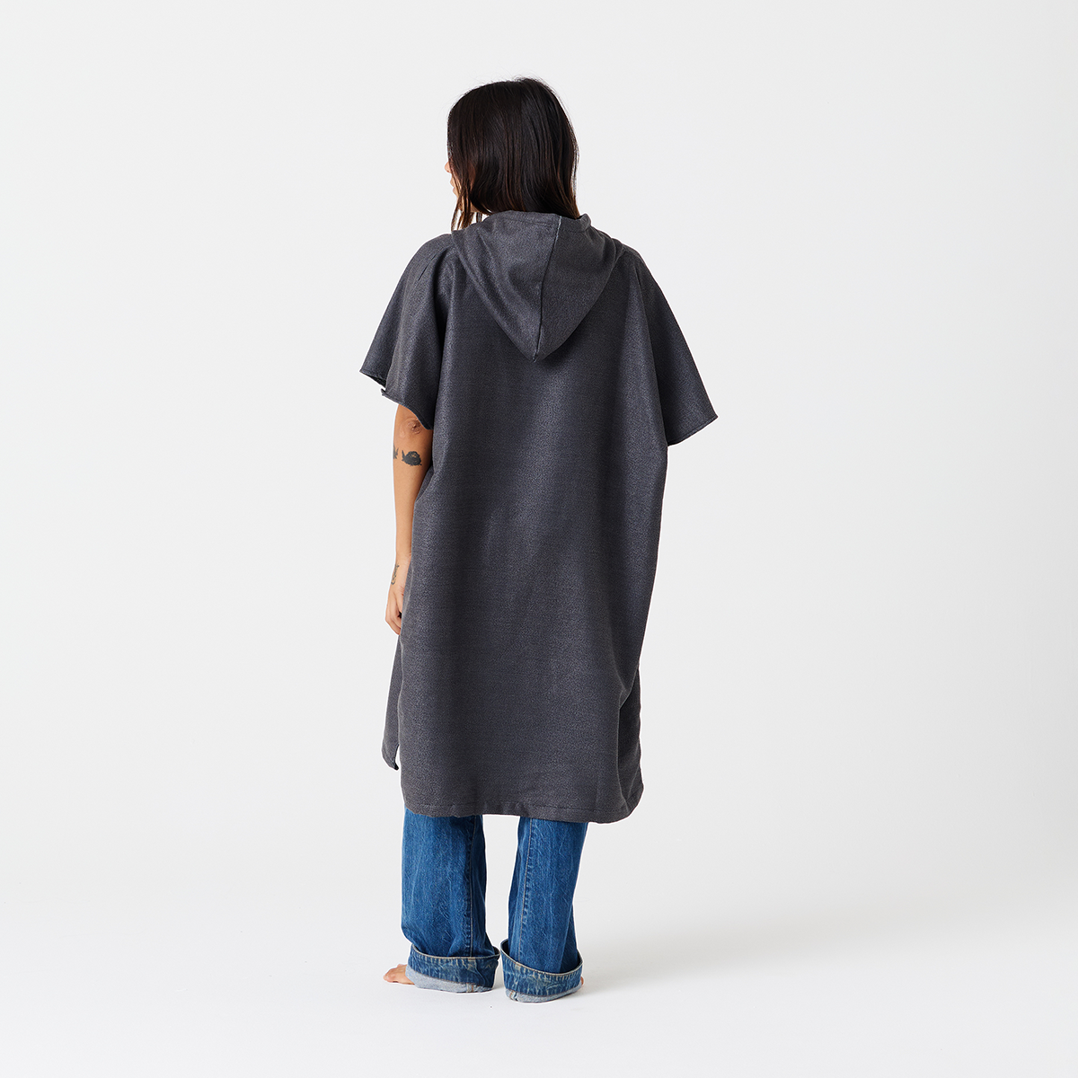Gray quick-drying changing poncho with jeans, back view.