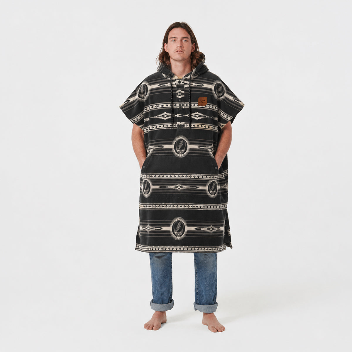 Patterned changing poncho with rolled-up hem, likely cotton or microfiber, studio setting.