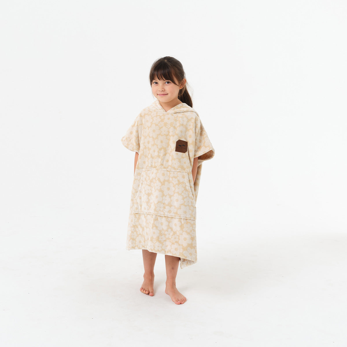 Beige floral cotton terry hooded towel with floral pattern.