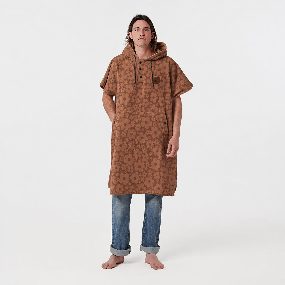 Cotton poncho with brown floral pattern.
