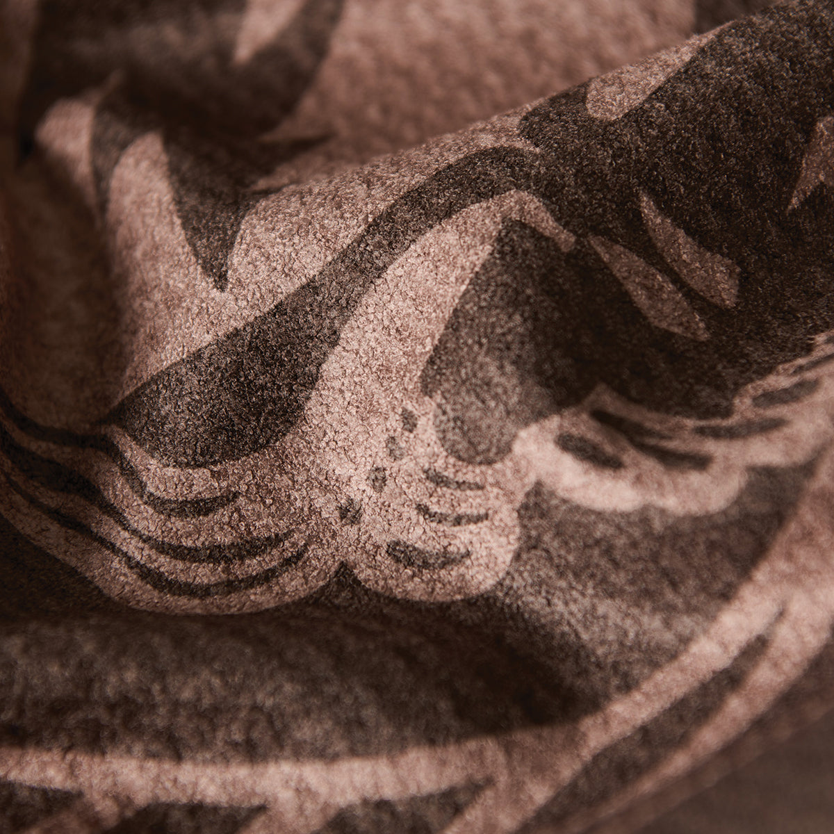 Waffle towel with dark abstract pattern and textured absorbent surface.
