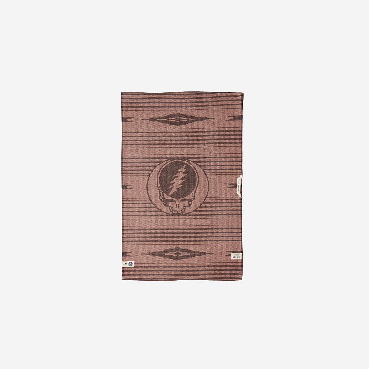 Brown towel, absorbent material with skull logo and geometric pattern, for bathroom or beach use.