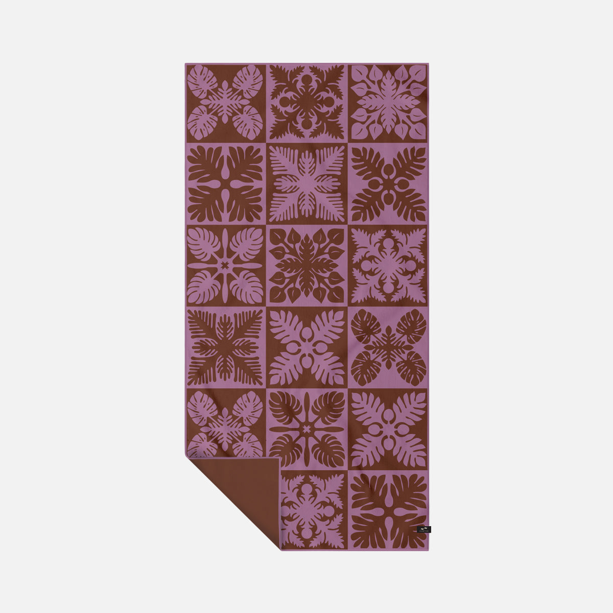 Quick-drying towel with purple-brown floral quilt pattern and plain brown corner.
