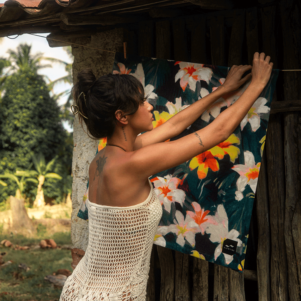 Colorful absorbent towel with vibrant pattern hanging outdoors.