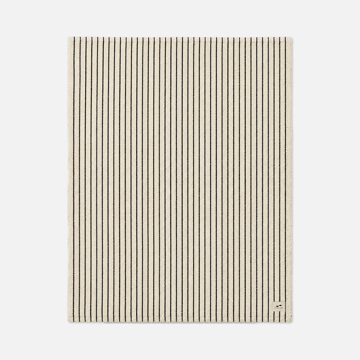 Beige rectangular rug with thin black stripes, suitable for layering with blankets.