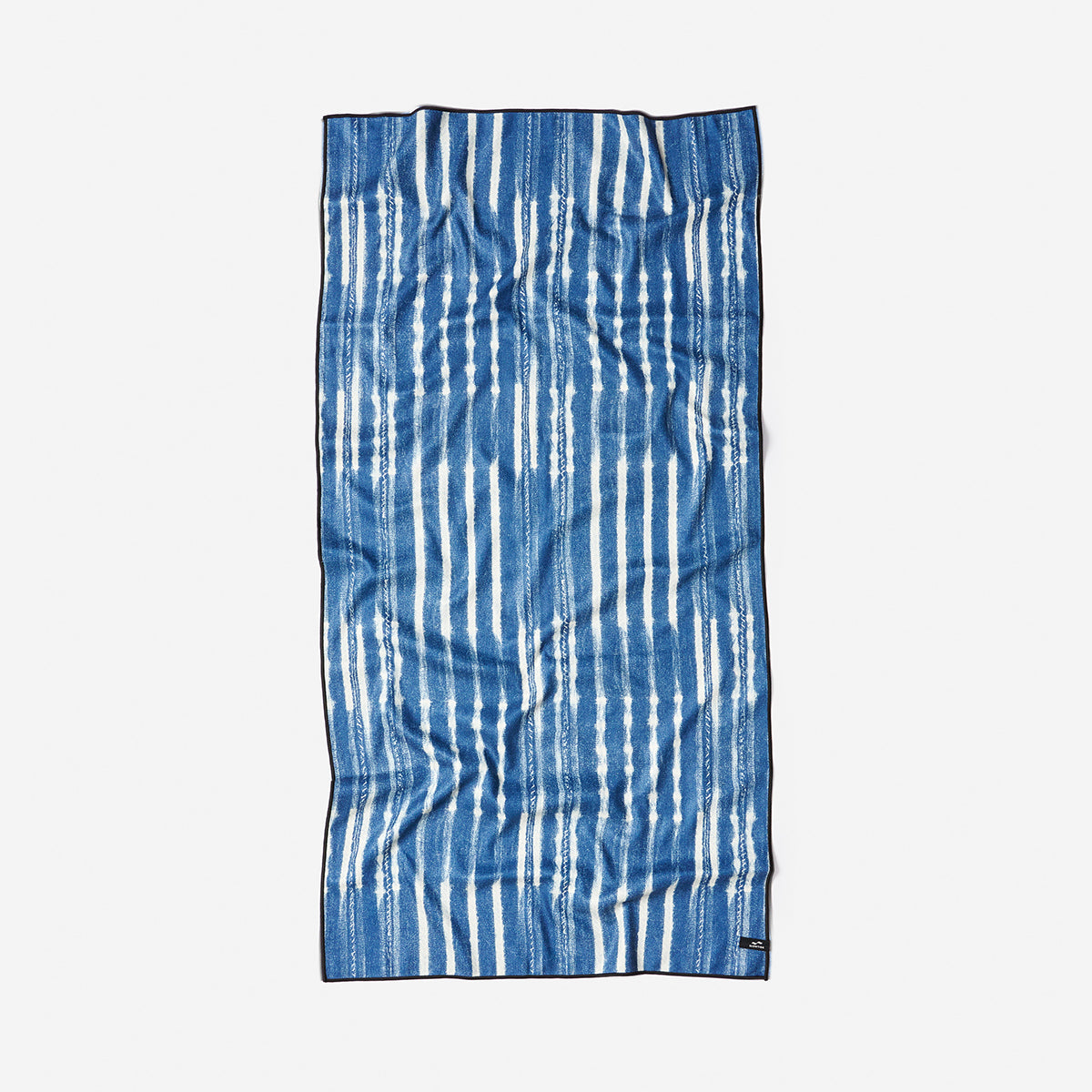 Beach towel, quick-drying fabric, blue with vertical white stripes, slightly wrinkled texture.