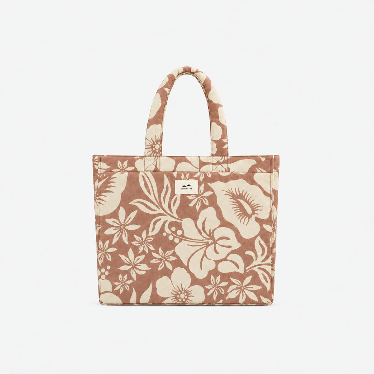 Cotton tote bag with beige floral print and two handles.