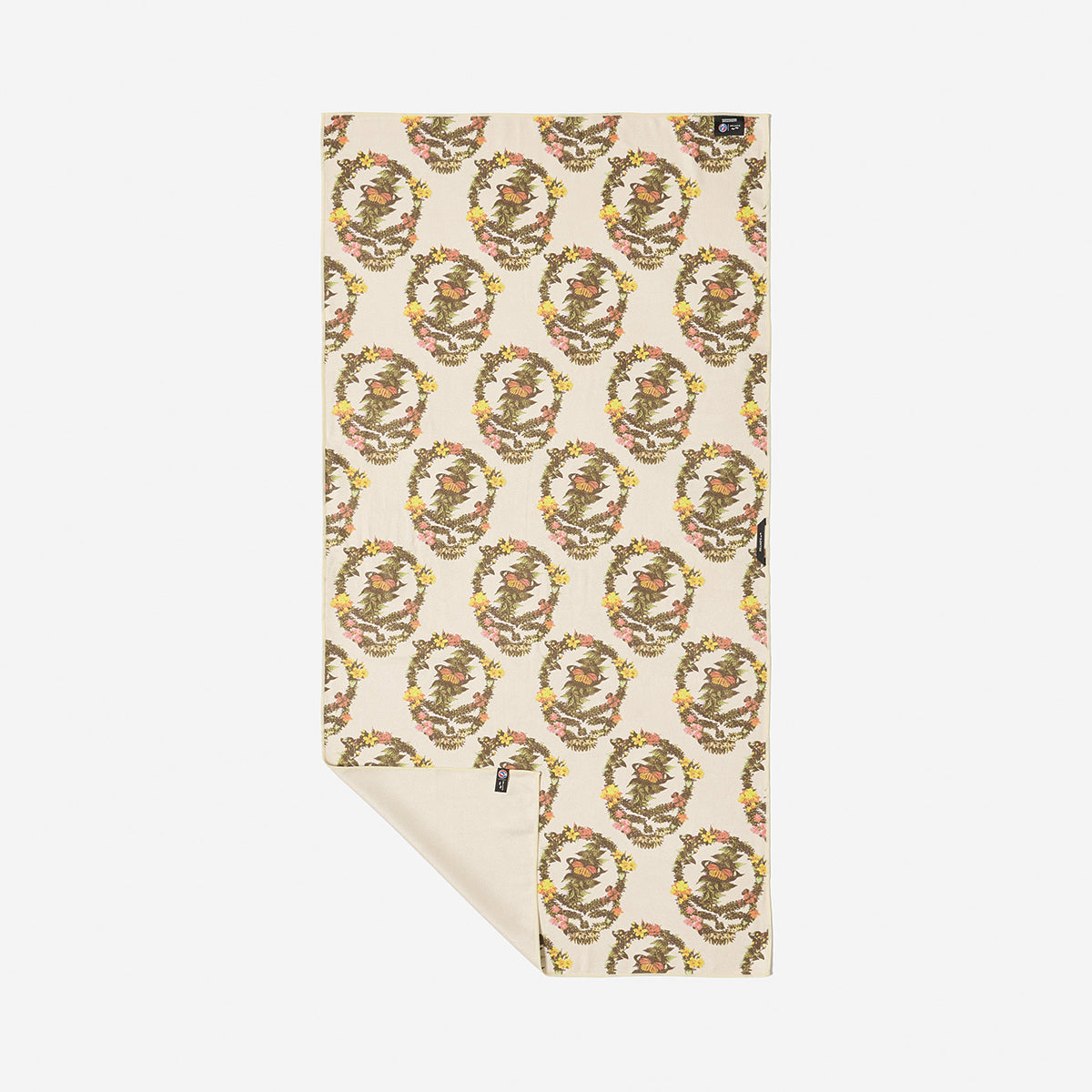 Beige floral towel with pink, yellow, and green wreath pattern.