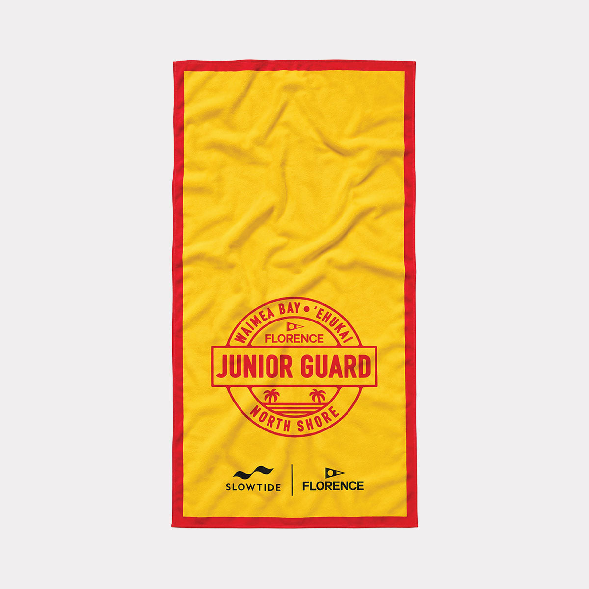 Beach towel in yellow quick-dry fabric with red trim and Junior Guard North Shore graphic.