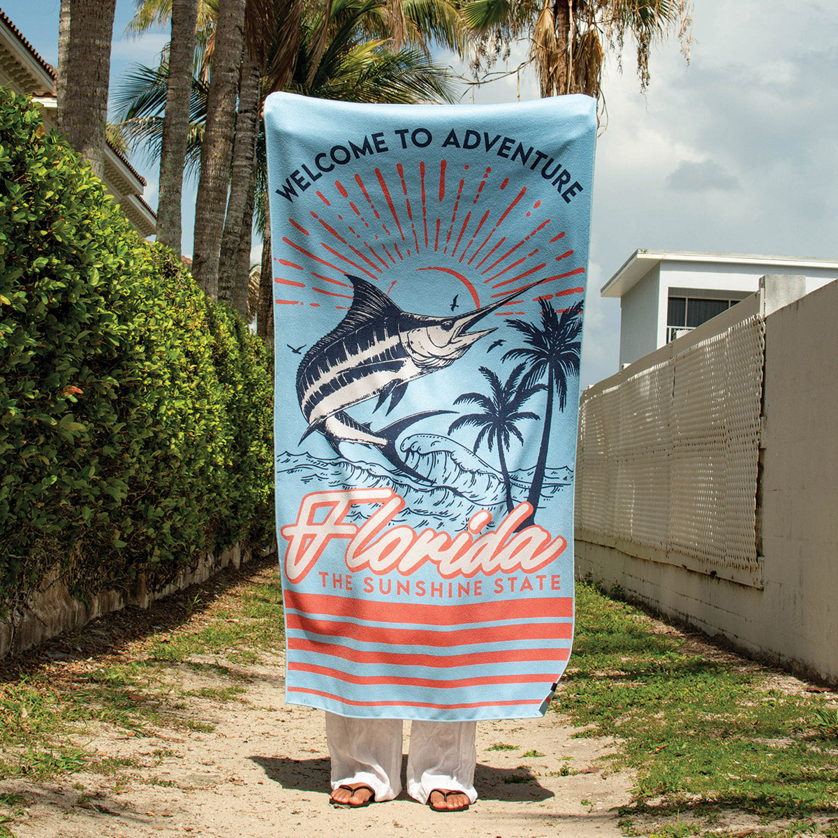 Beach towel with palm tree and marlin design, highly absorbent and quick-drying.