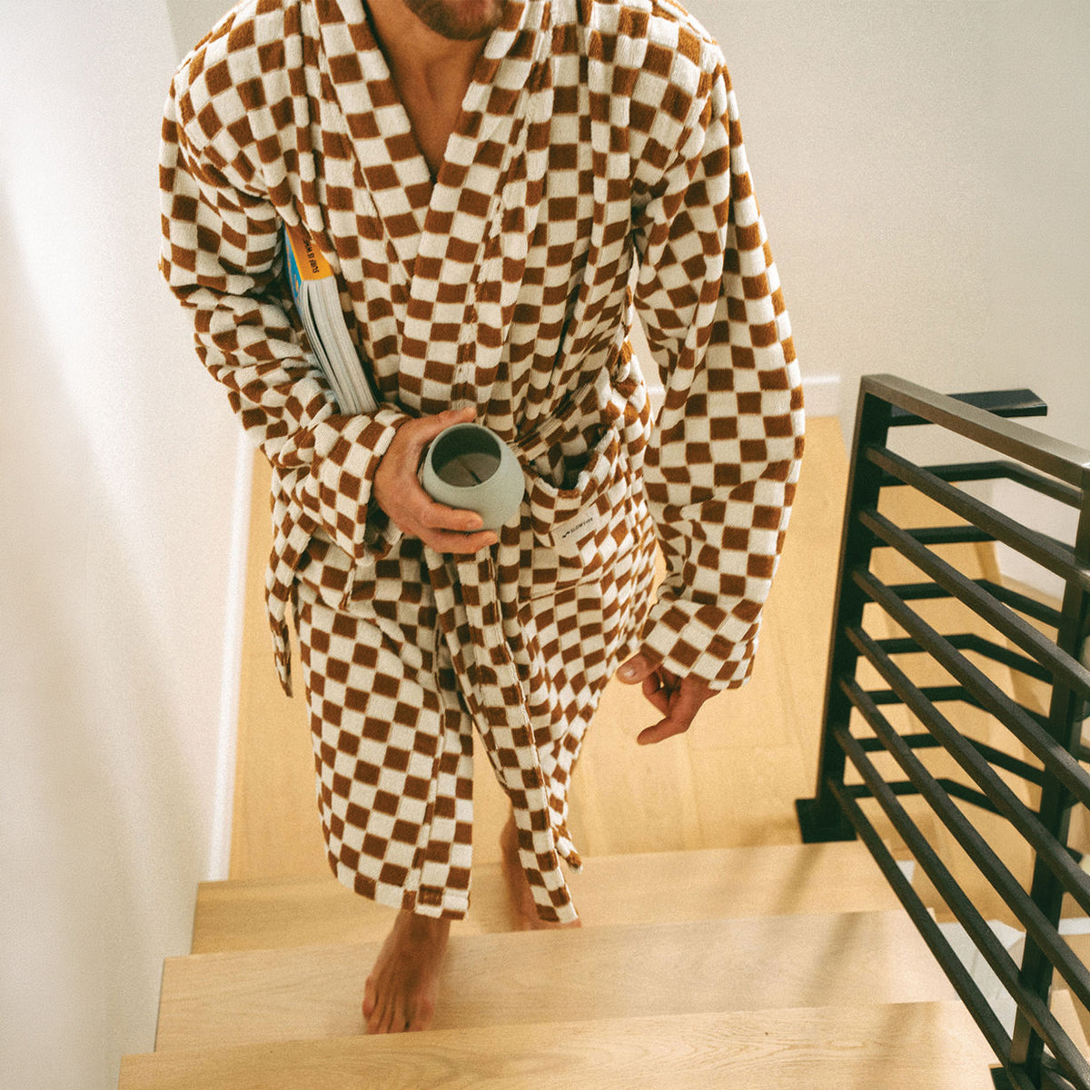 Plush bathrobe in a brown and white checkered pattern.