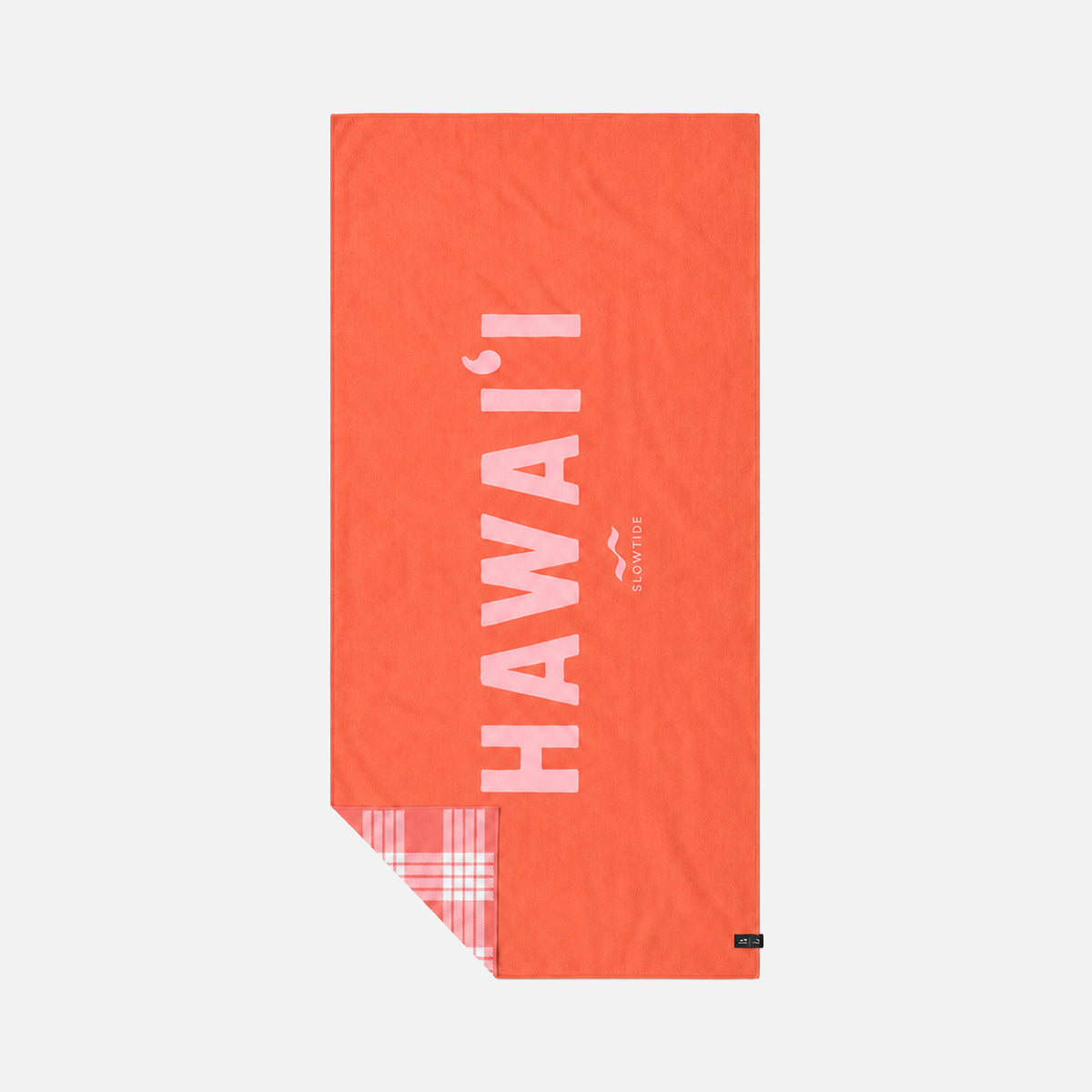 Red quick-dry towel with white text and plaid corner detail.