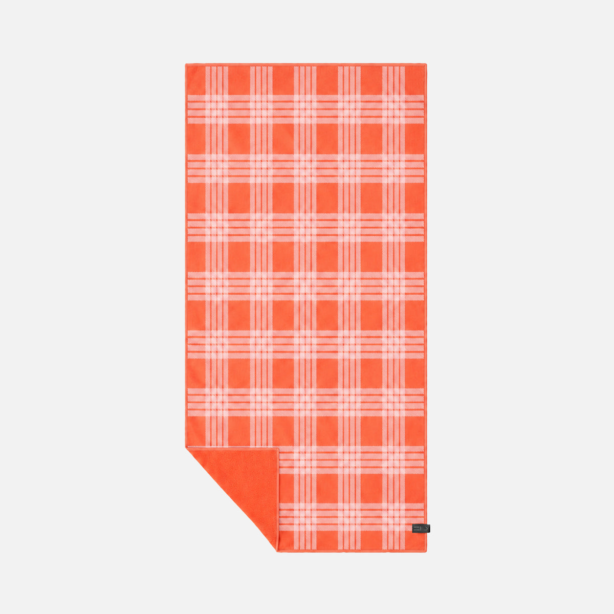 Plaid quick-drying towel in red and pink with folded corner.