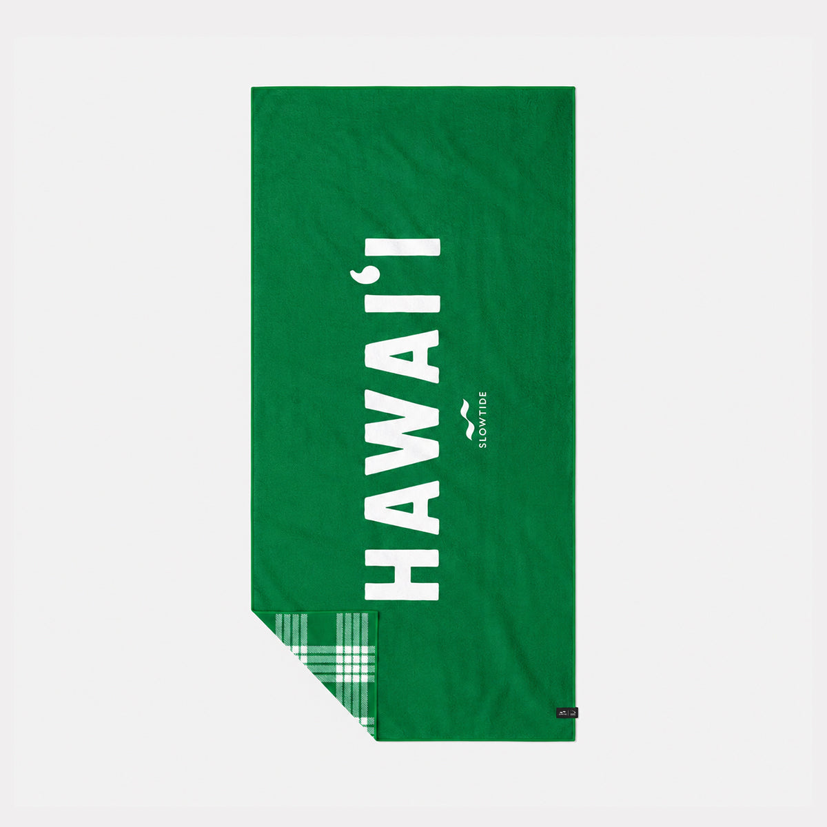 Green eco towel with HAWAII text and green plaid corner detail.