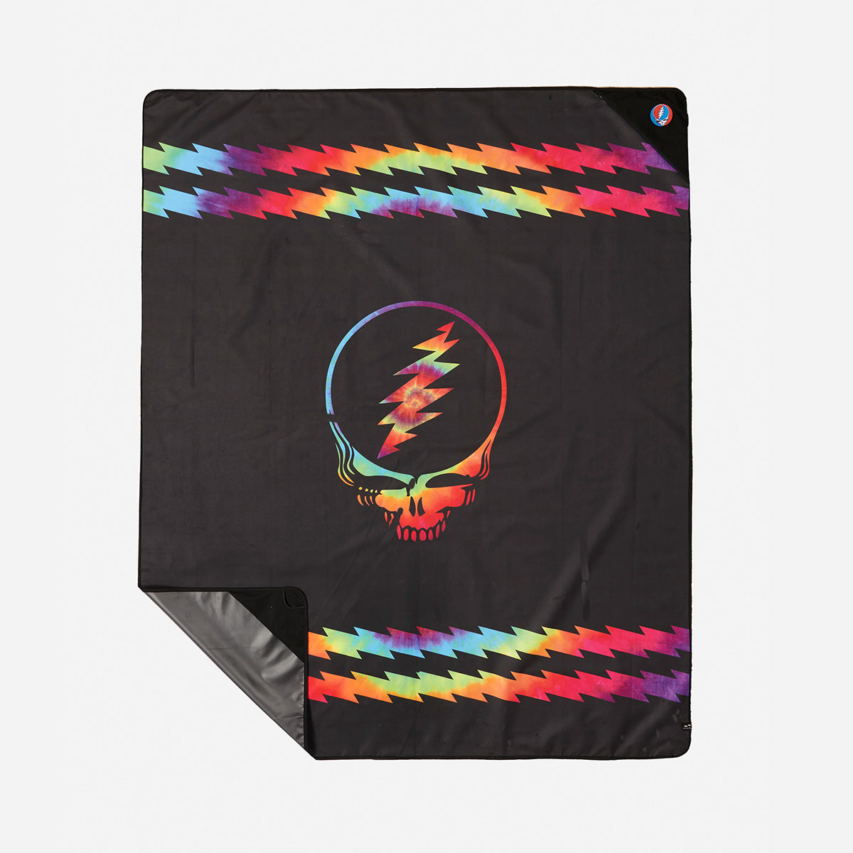 Blanket in black recycled material with colorful skull, lightning bolt, and zigzag rainbow borders.