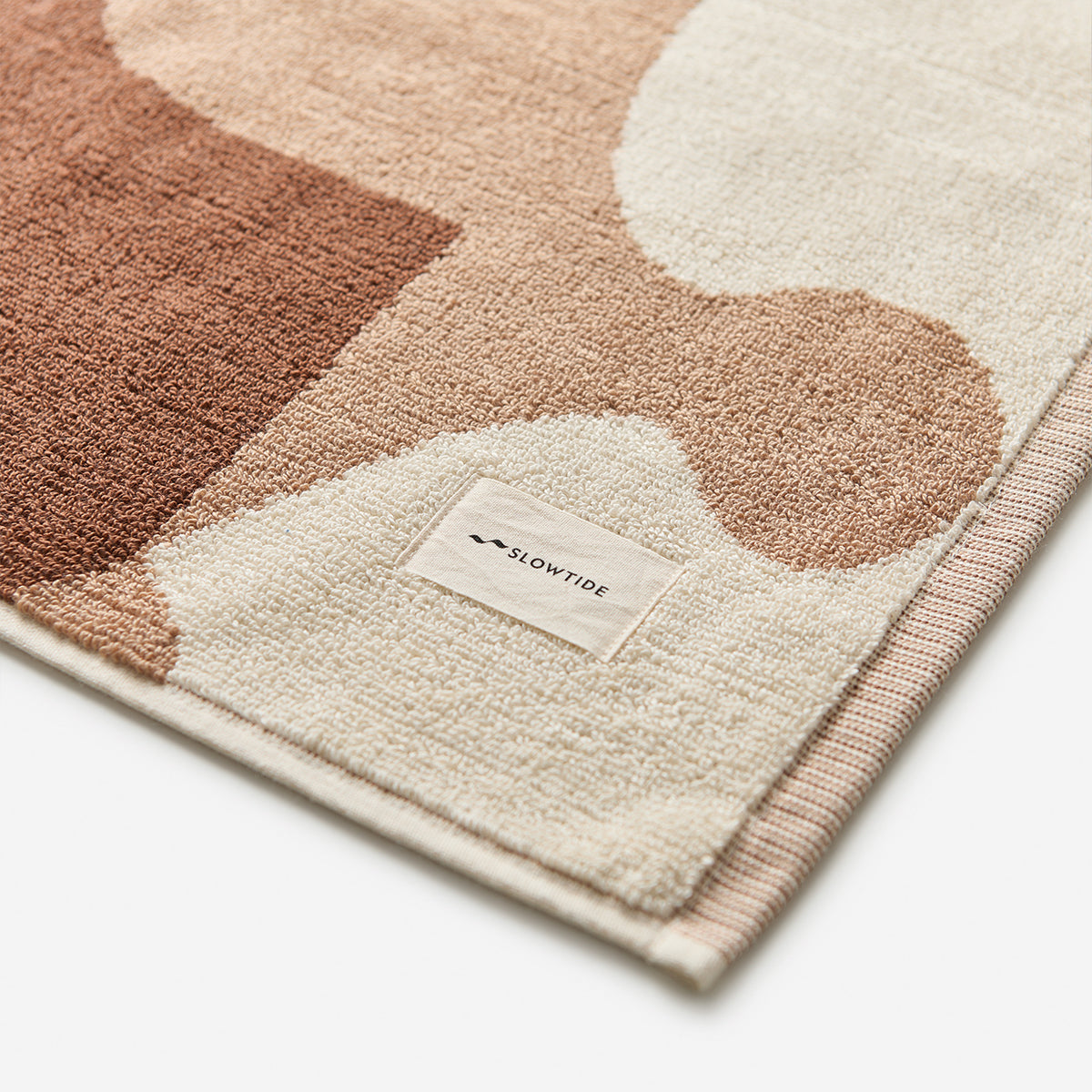 Cotton towel with a brown and cream abstract pattern.