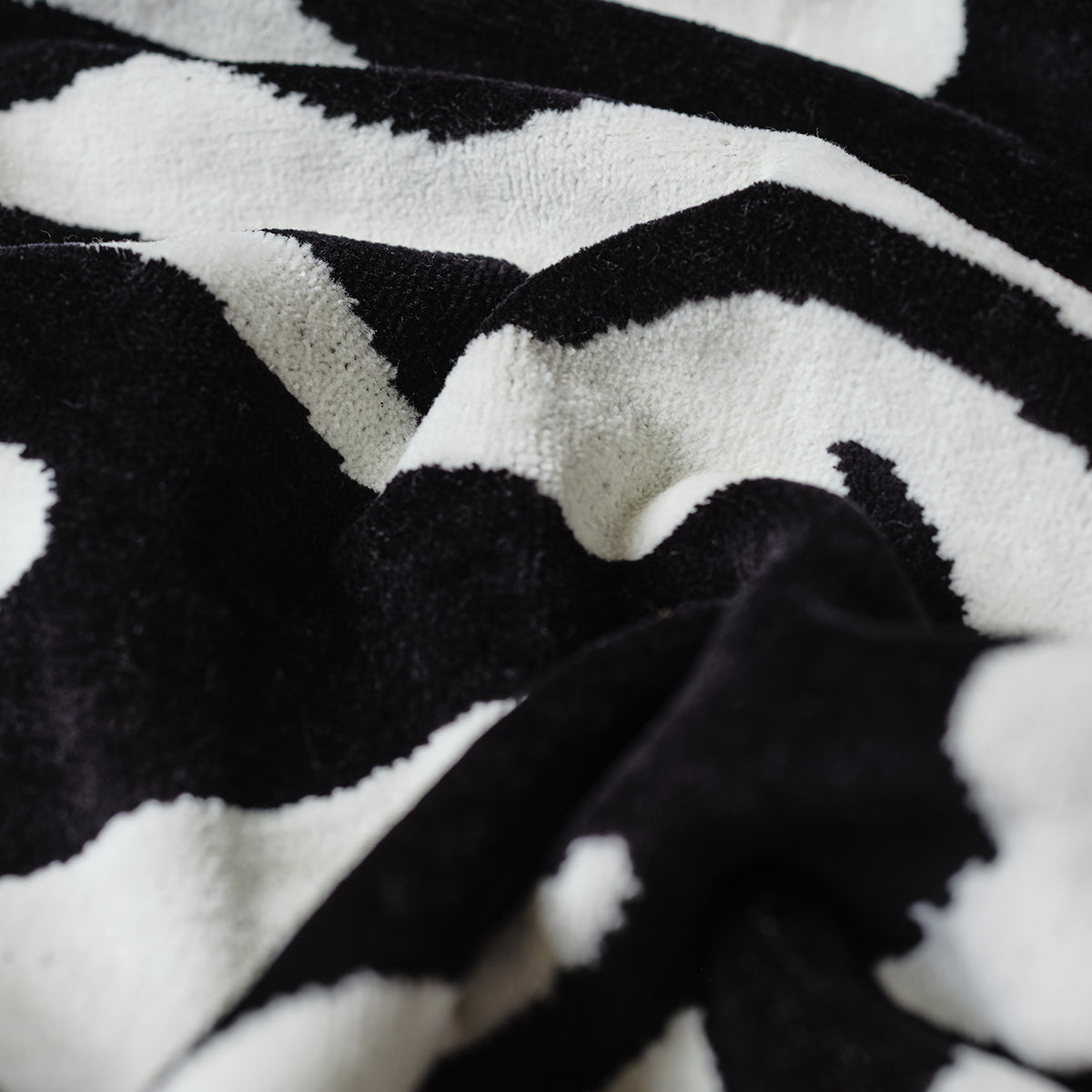 Zebra print tote bag in soft textured fabric with subtle folds.