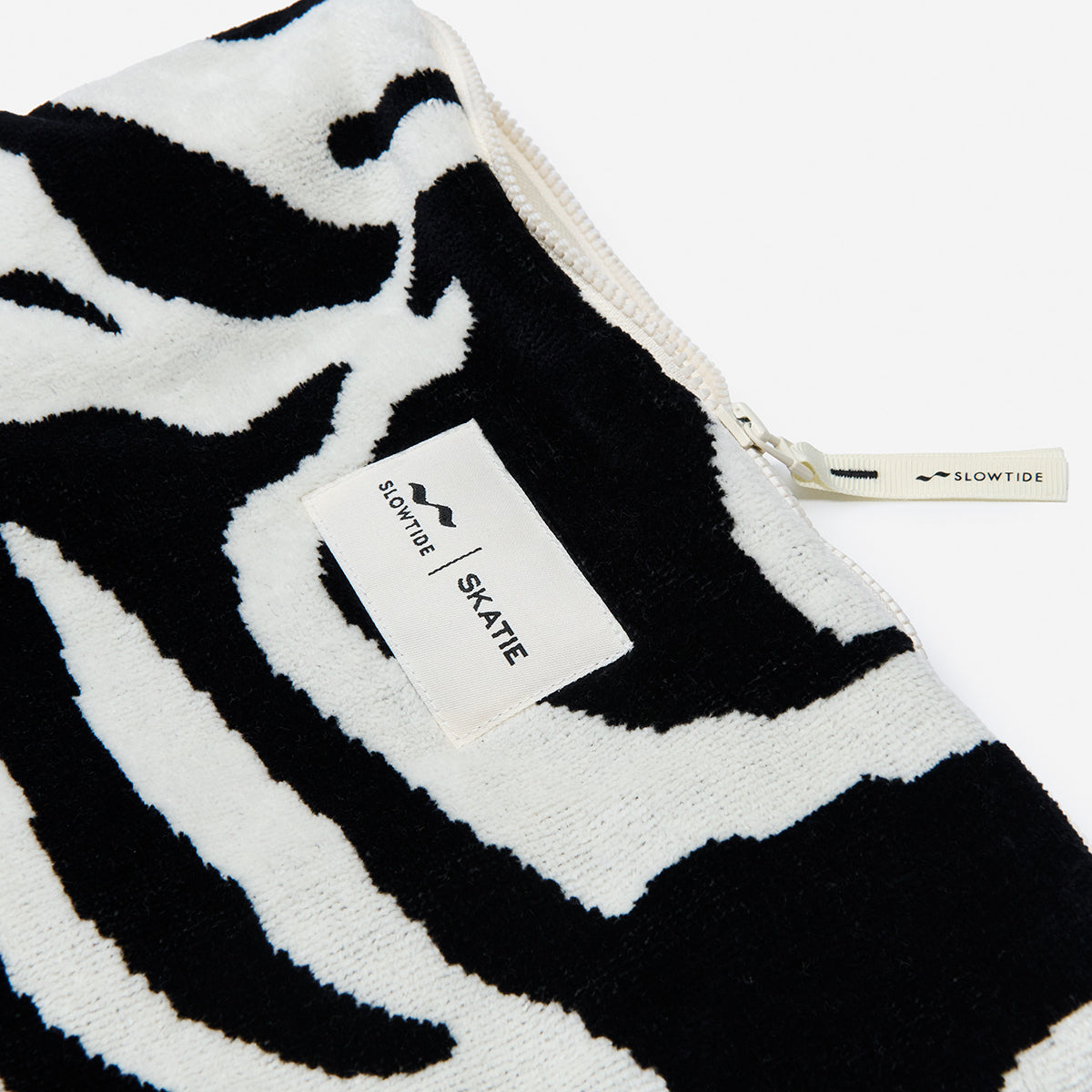 Terry pouch cotton canvas with black and white zebra print and zipper.