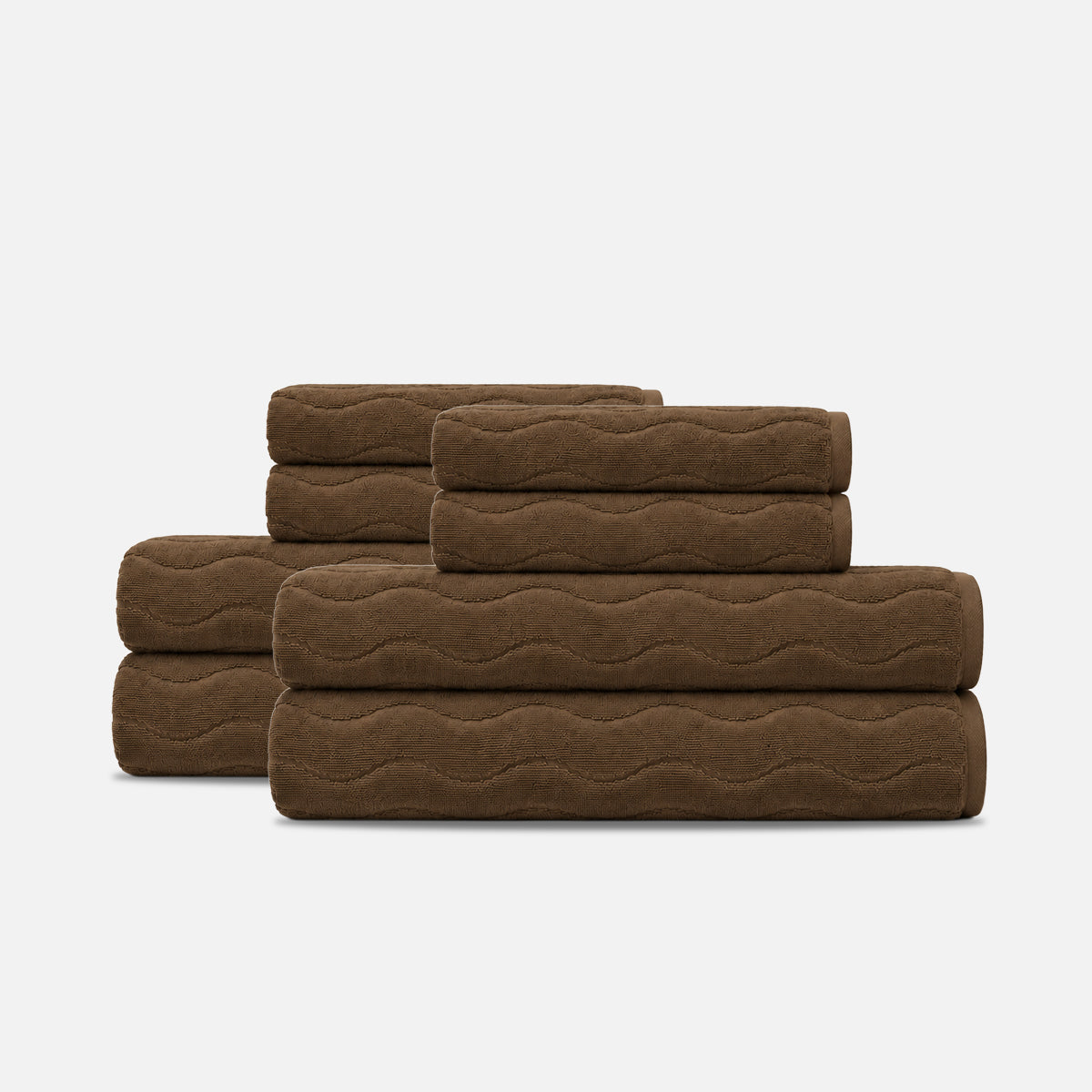 Brown bath towel set in plush cotton with a sculpted wave texture.