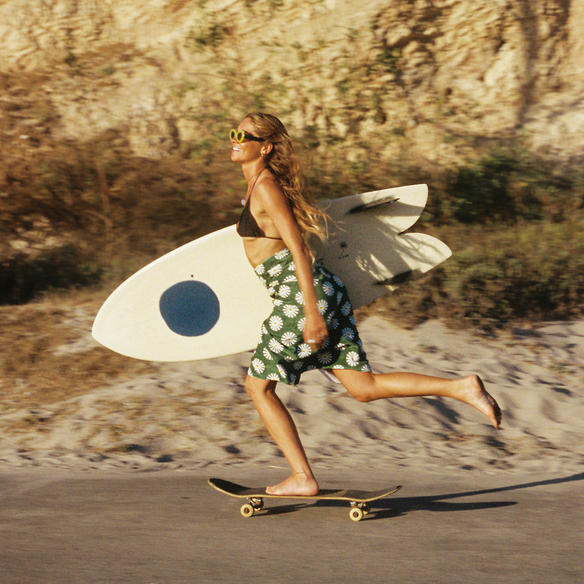 Absorbent cotton towel with surfboard, shown outdoors.