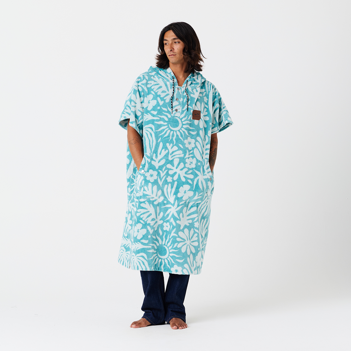 Cotton terry towel poncho with blue floral pattern.