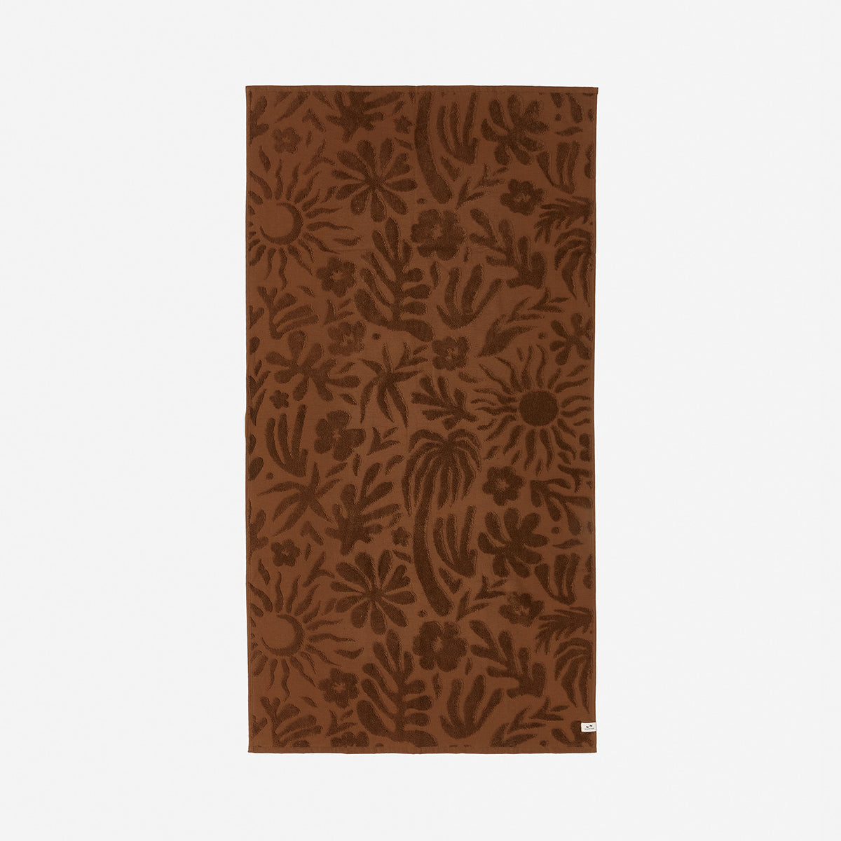 Brown plush bathroom towel with floral and sun print.