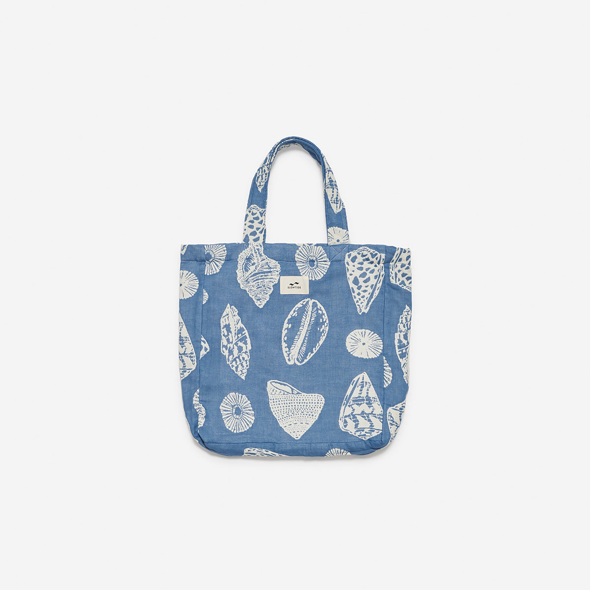 Cotton tote bag with white seashell pattern and two handles.