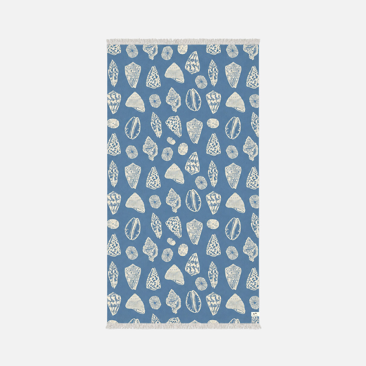 Blue sand-resistant towel with white seashell and coral pattern, fringed edges.