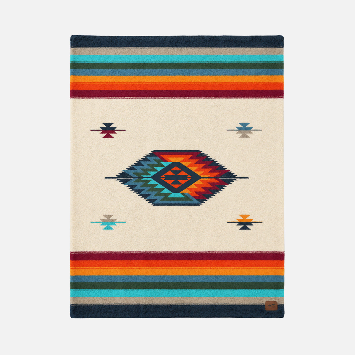 Plush throw blanket with colorful southwestern stripes and geometric shapes on cream background.