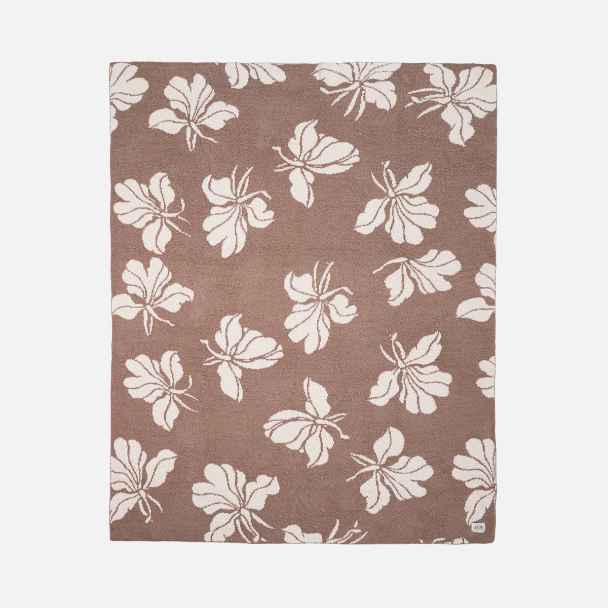 Plush reversible throw blanket with brown and cream floral pattern.