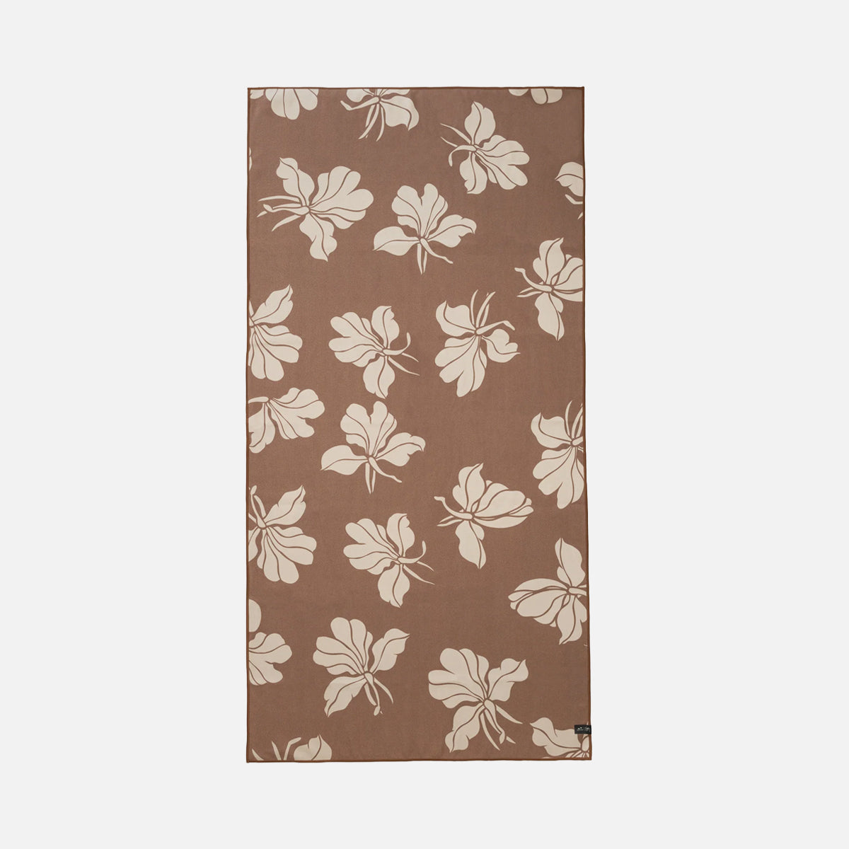 Beach towel in sand-resistant brown with cream floral pattern.