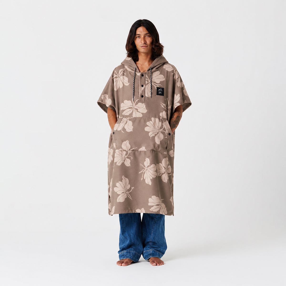 Quick-dry changing poncho in taupe with white floral pattern and front pocket.