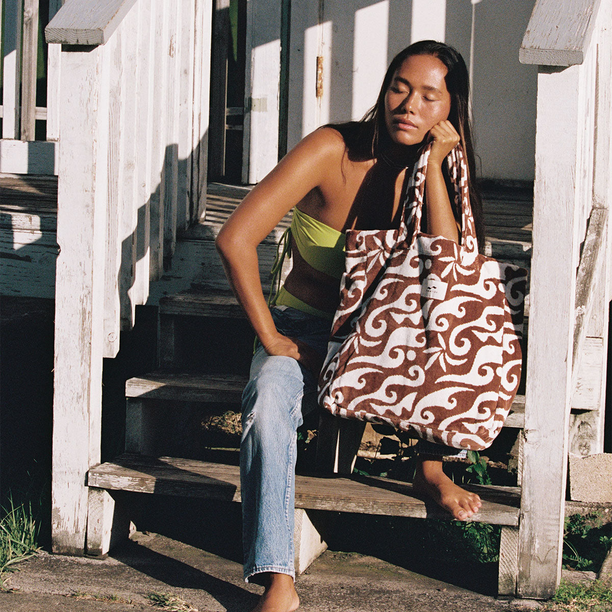 Large tote bag in toast color, carried outdoors in sunlight.