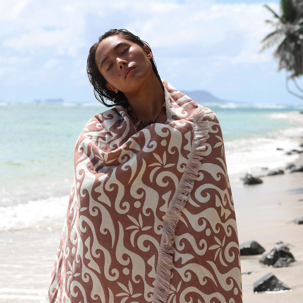 Oversized beach towel with plush fabric and simple design, shown at the beach.