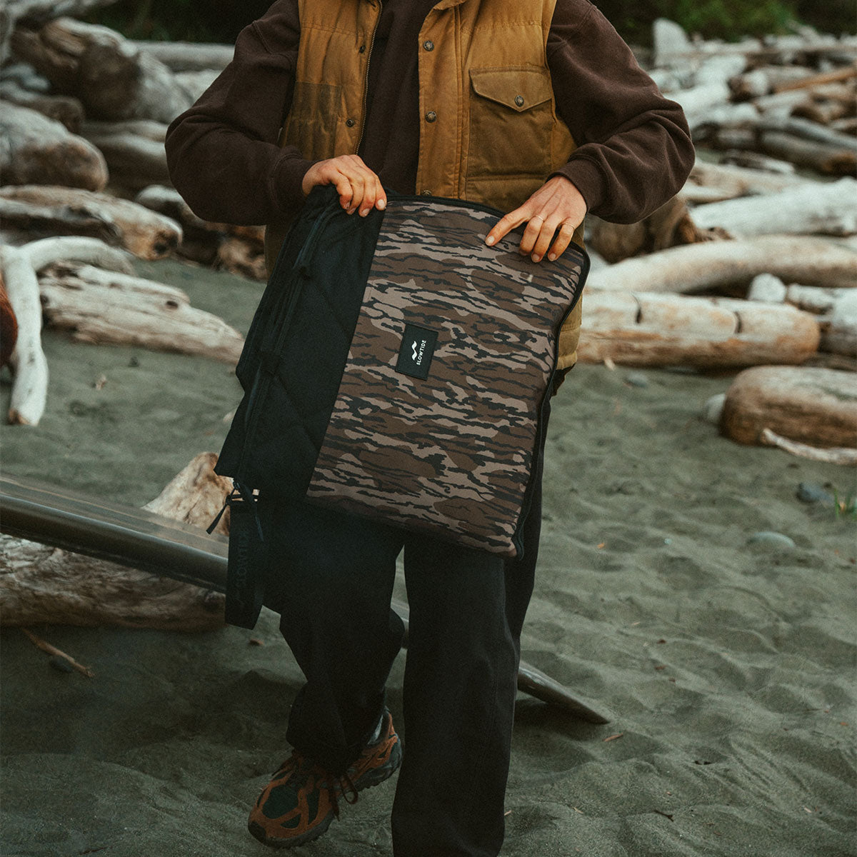 Laptop sleeve in a brown and black camouflage pattern for beach use.