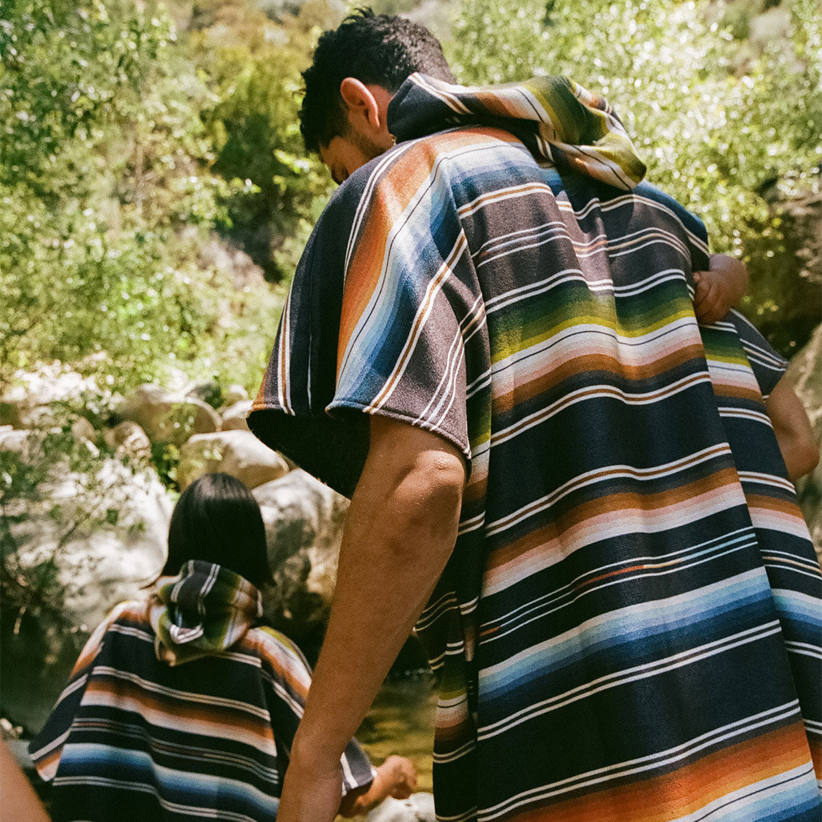 Sand-resistant quick-dry changing ponchos outdoors in sunlight.