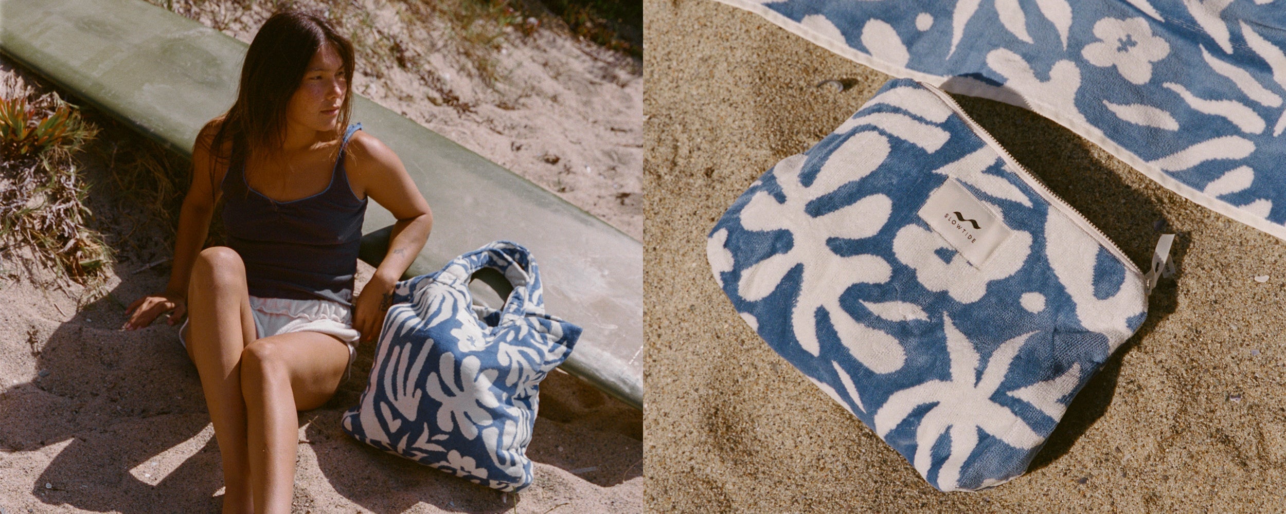 A woman sits on sand near a surfboard, next to a blue and white floral bag. Beside her is a close-up of a matching zip pouch on the sand, with part of a patterned towel visible.