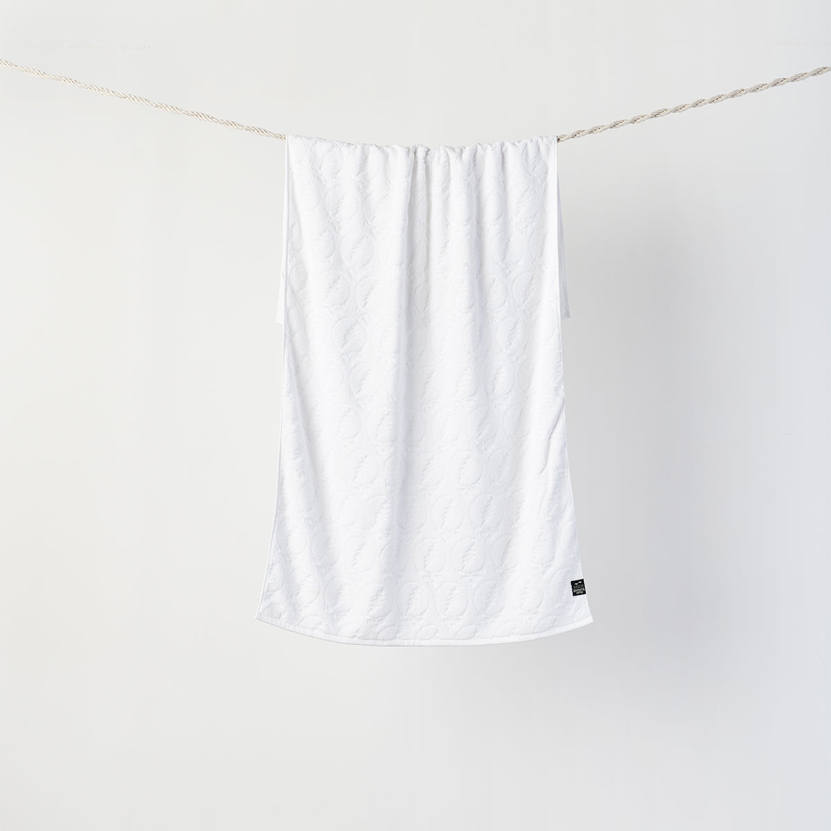 Bath towel, customizable design, displayed hanging against white background.