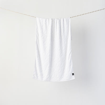 Bath towel, customizable design, displayed hanging against white background.