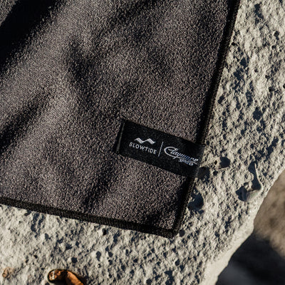 Quick-drying dark textured towel on rough stone.
