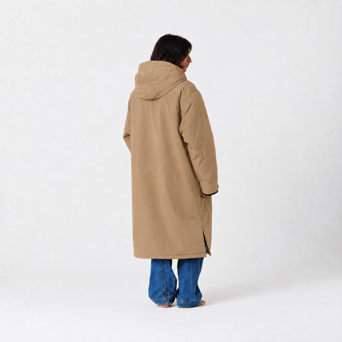 Tan all-weather parka with hood, paired with blue jeans, shown from the back.