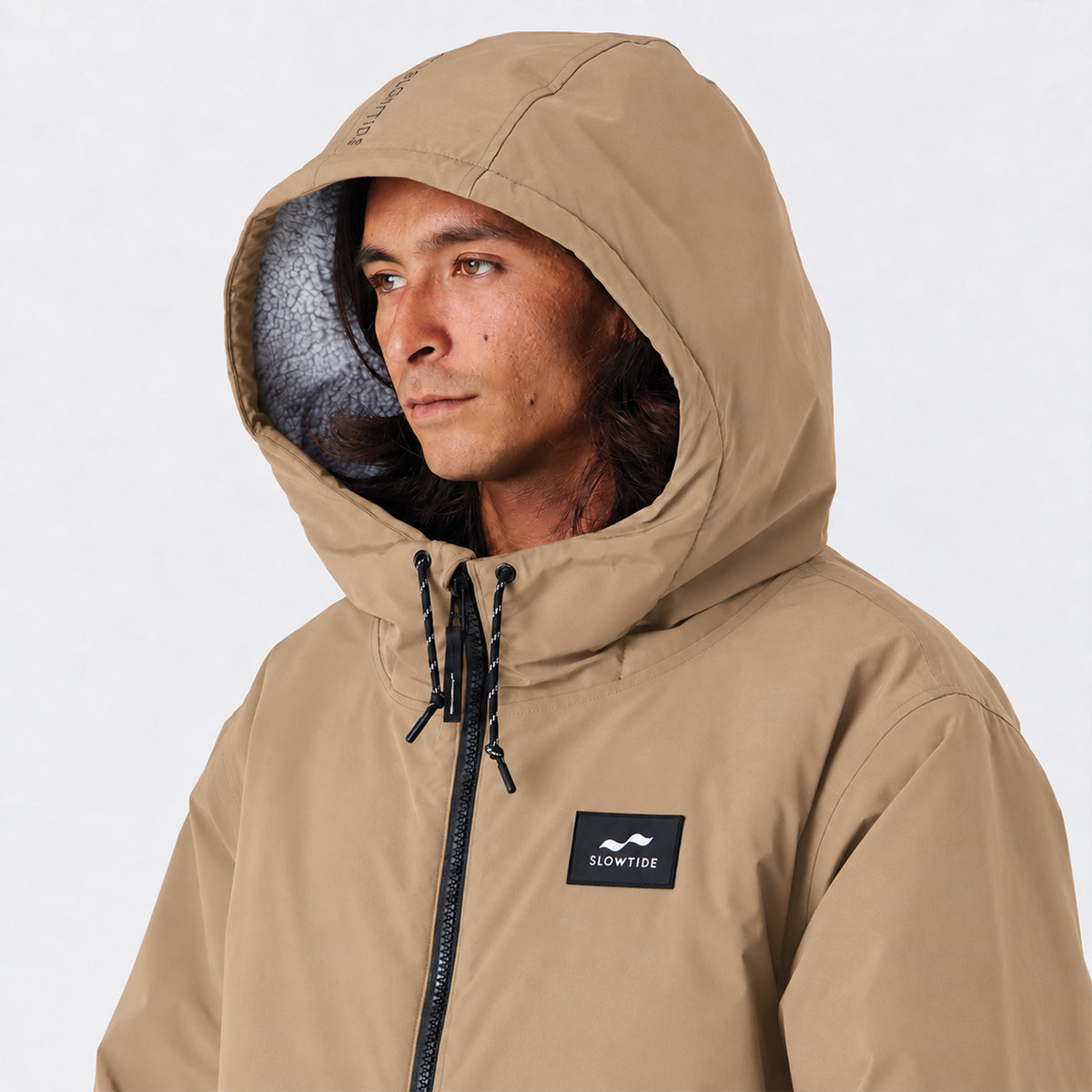 Tan hooded all-weather parka with insulation for comfort and style.