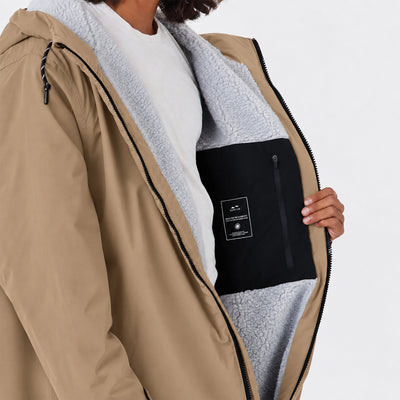 Tan jacket with gray fleece lining and black inner pocket, insulated for warmth.