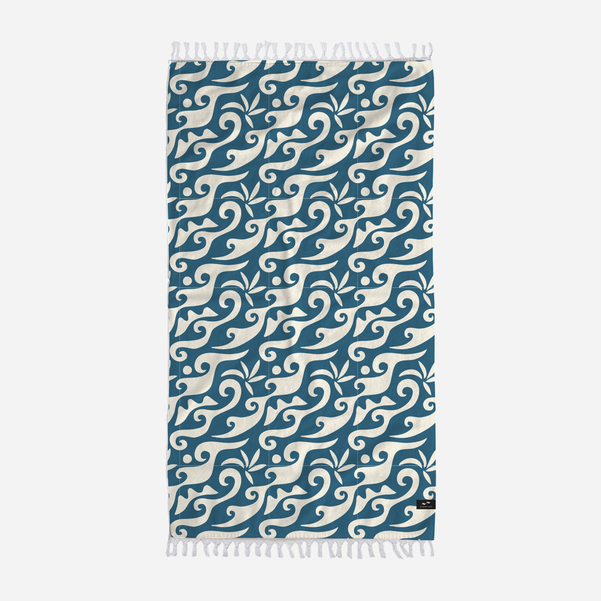 Cotton towel with ocean blue and white wave pattern, fringed edges.